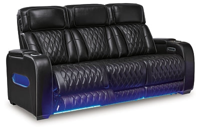 Boyington Power Reclining Sofa by Ashley Furniture, shown from an angle with open recliner, plush fabric and padded armrests.