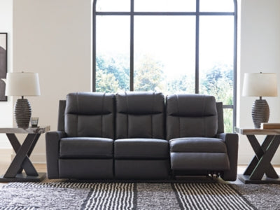 Ashley Furniture Mackmenville reclining sofa shown in an open position with plush cushions and dark upholstery on a modern living room setting.