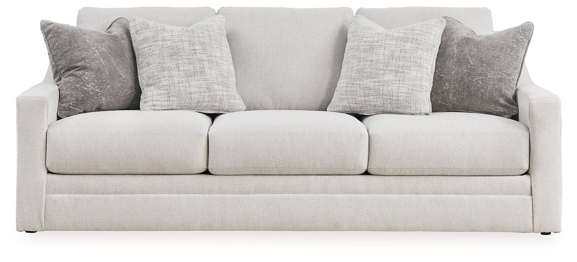 Ashley Furniture Adda sofa with plush cushions and neutral fabric, shown head-on in a modern living room setting.