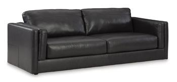 Ashley Furniture Amiata Sofa with plush beige upholstery and modern design, shown in a stylish living room setting.