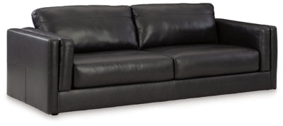 Ashley Furniture Amiata sofa shown from an angled view, featuring plush cushions and modern design in a stylish living room setting.