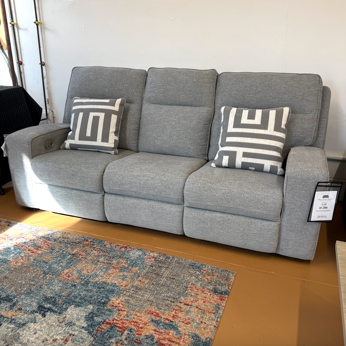 Ashley Furniture Biscoe Power Reclining Sofa with plush cushions and reclining features, shown in a modern living room setting.