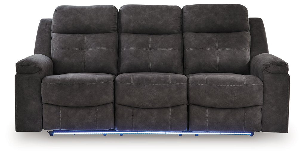 Ashley Furniture Brysonview reclining sofa with plush white fabric and padded armrests, shown from a front head-on perspective.