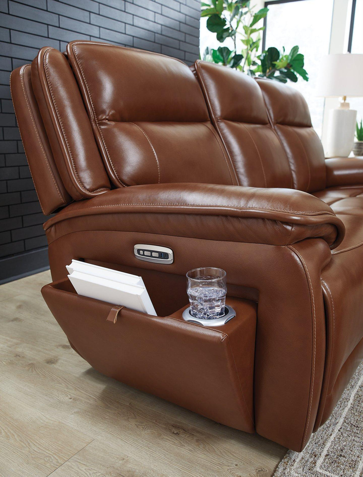 Healy Pier Power Reclining Sofa by Ashley Furniture, featuring plush fabric, padded armrests, and a built-in reclining mechanism.