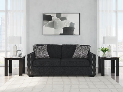 Ashley Furniture Jasmine Peaks Sofa with plush fabric and modern design, featuring cushioned armrests and decorative throw pillows.