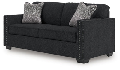 Ashley Furniture Jasmine Peaks sofa shown from an angled view, featuring plush cushions and neutral upholstery for a comfortable living room.