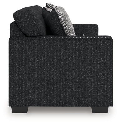 Ashley Furniture Jasmine Peaks sofa with plush cushions and fabric upholstery, shown from the side.
