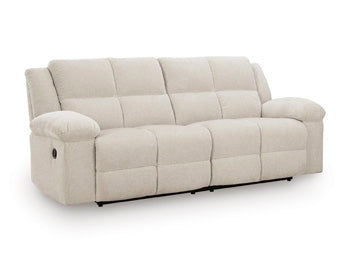 Ashley Furniture Orlen reclining sofa shown from an angle, featuring plush cushions and a modern design in a cozy living room setting.