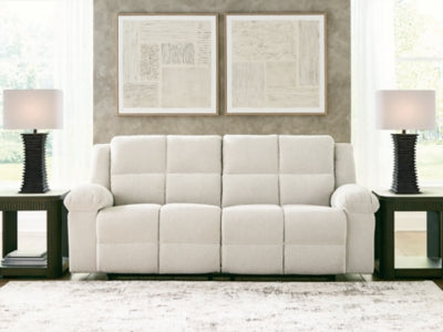 Ashley Furniture Orlen reclining sofa with plush fabric and wide armrests, shown in a close-up view.