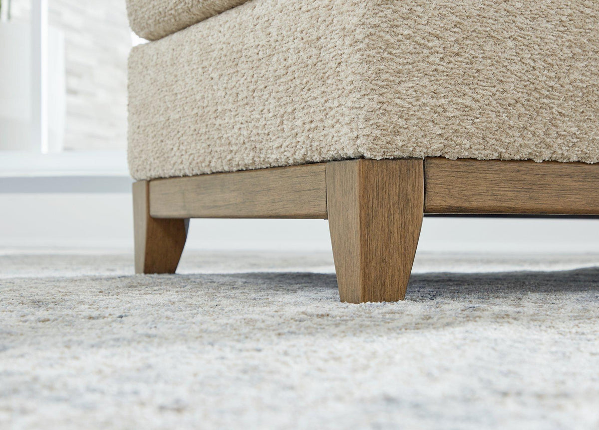 Ashley Furniture Parklynn Sofa with plush fabric and modern design, featuring tufted cushions and wide armrests.