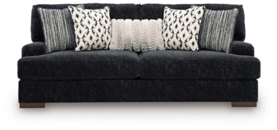 Ashley Furniture Whitmore Manor sofa with plush beige upholstery and tufted back, shown from a front head-on view.