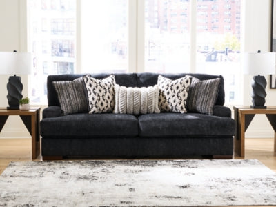 Ashley Furniture Whitmore Manor sofa featuring plush fabric, cushioned arms, and elegant design, perfect for living room decor.