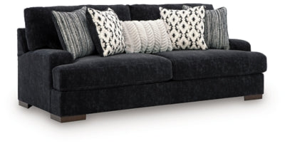 Ashley Furniture Whitmore Manor sofa shown from an angled side view, featuring plush upholstery and elegant design.
