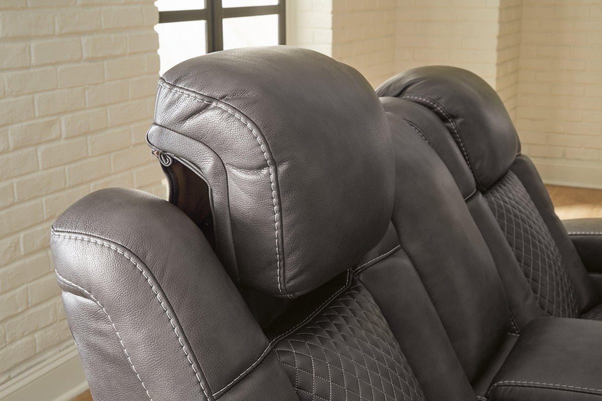 Ashley Furniture Fyne-Dyme Power Reclining Sofa with plush cushions and reclining features, shown in a modern living room setting.