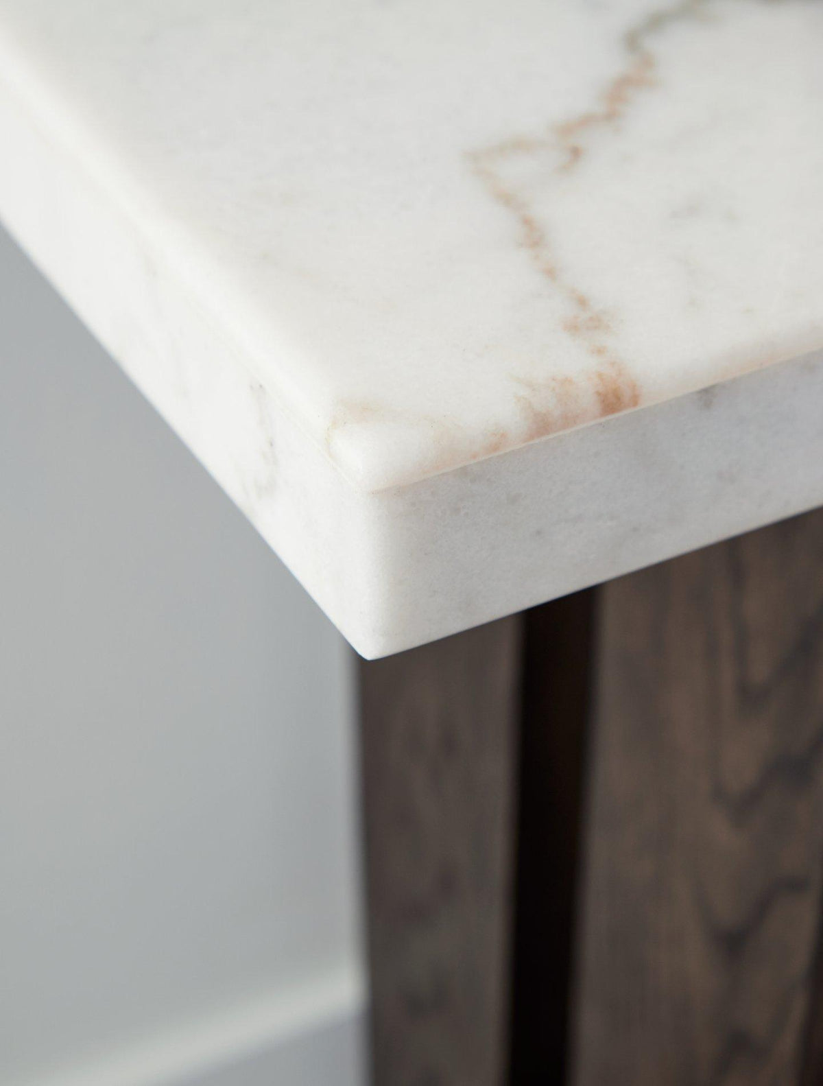 Ashley Furniture Burkhaus sofa table with a sleek wooden surface and modern design, perfect for living room decor.