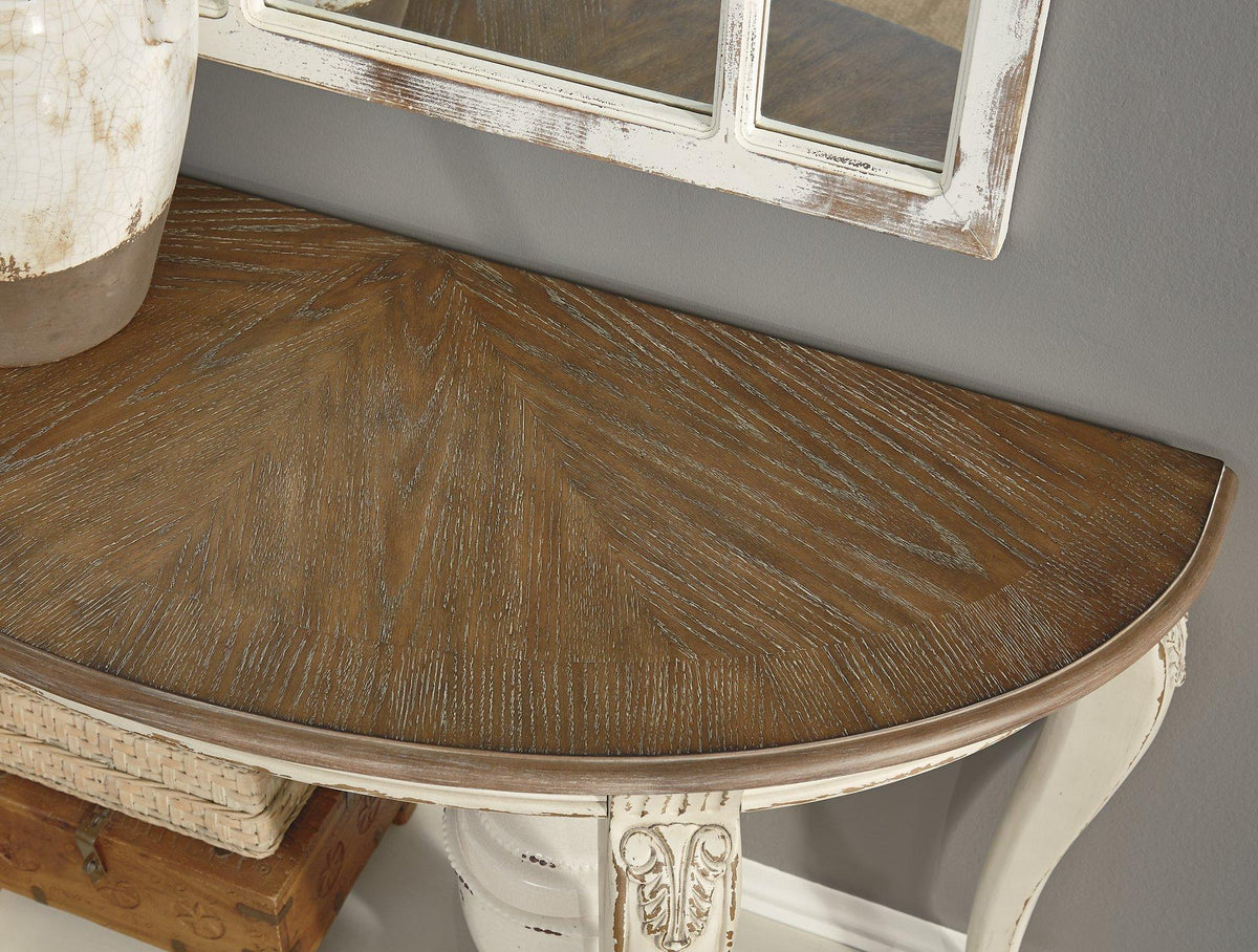 Ashley Furniture Realyn sofa table with a wood finish, featuring a rectangular top and open lower shelf for living room decor.