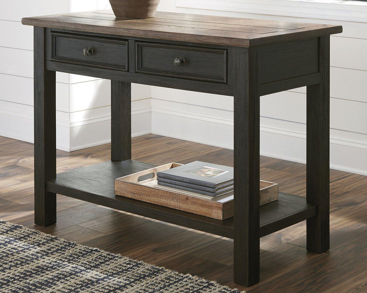 Ashley Furniture Tyler Creek sofa table showing a modern wooden console with clean lines and a warm finish.