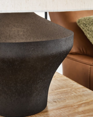 Dolanham Table Lamp by Ashley Furniture featuring a sleek modern design with a ceramic base and fabric shade.