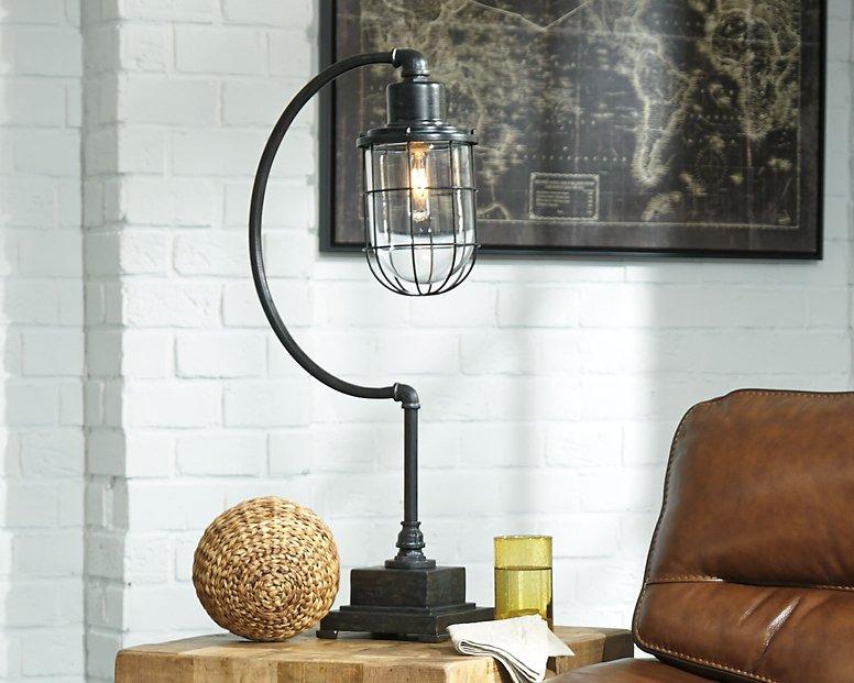 Ashley Furniture Jae desk table lamp with a sleek design, featuring a modern base and soft white lampshade.