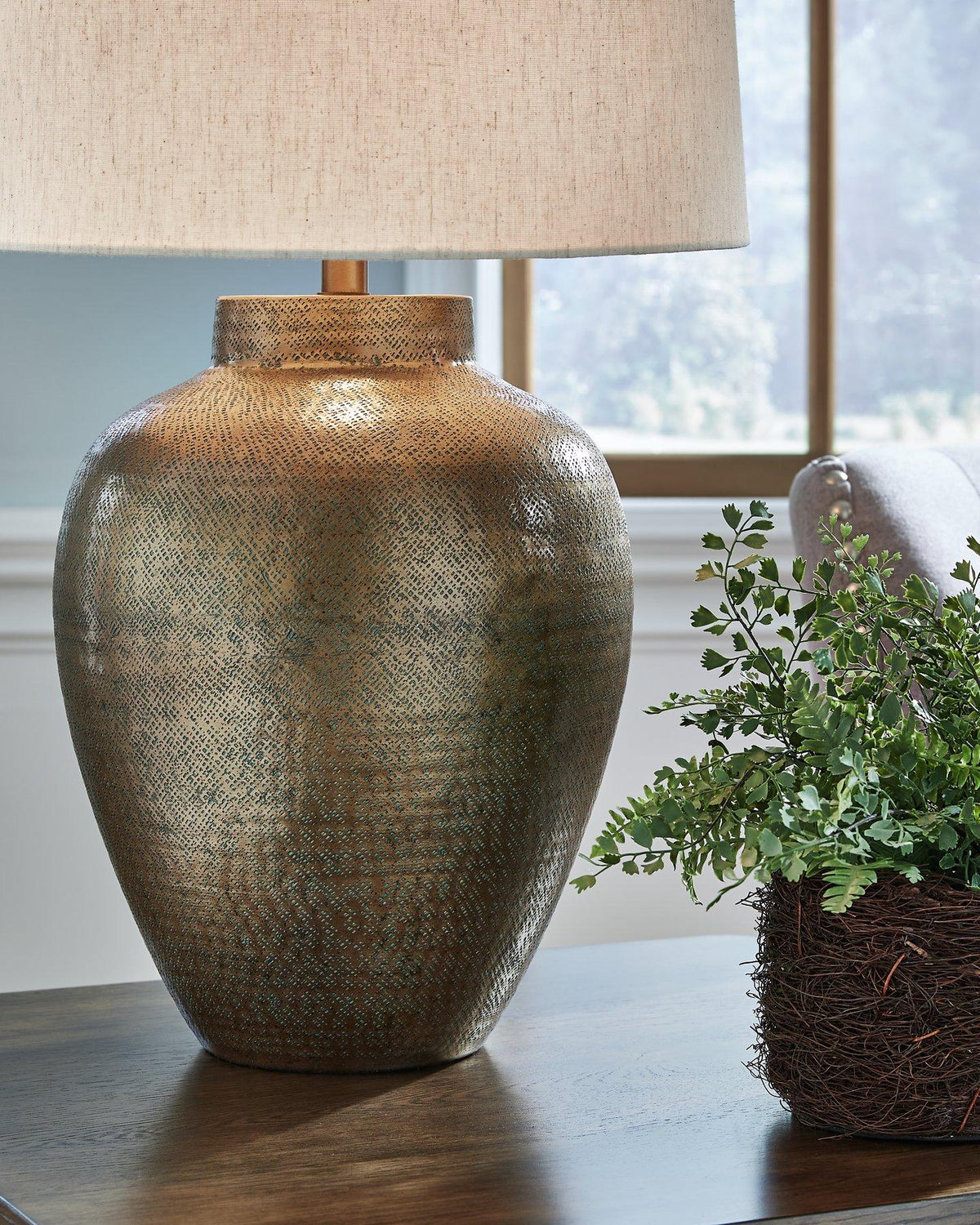 Madney Ashley Furniture table lamp with a sleek base and fabric shade, ideal for modern living room or bedroom decor.