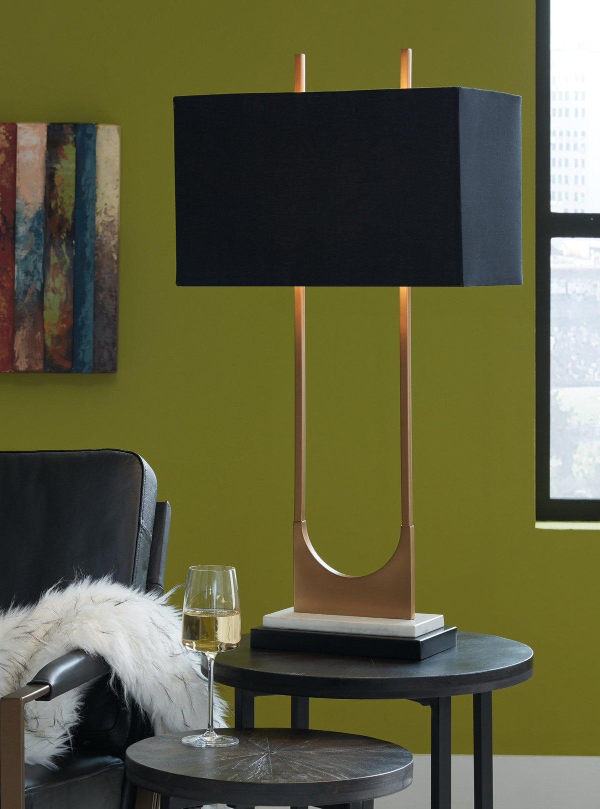 Malana table lamp by Ashley Furniture featuring a sleek design with a fabric shade and modern base for living room decor.