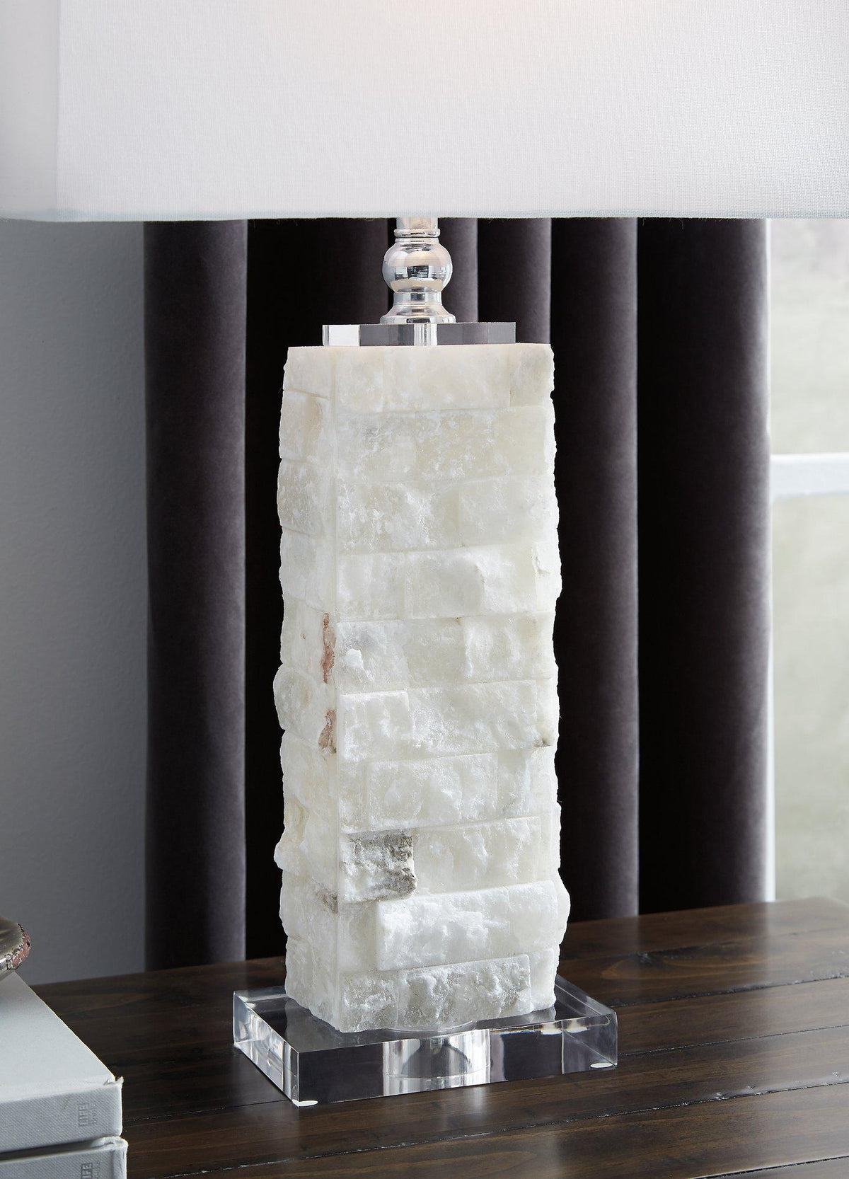 Malise table lamp by Ashley Furniture with a sleek modern design and a neutral fabric lampshade on a wooden base.