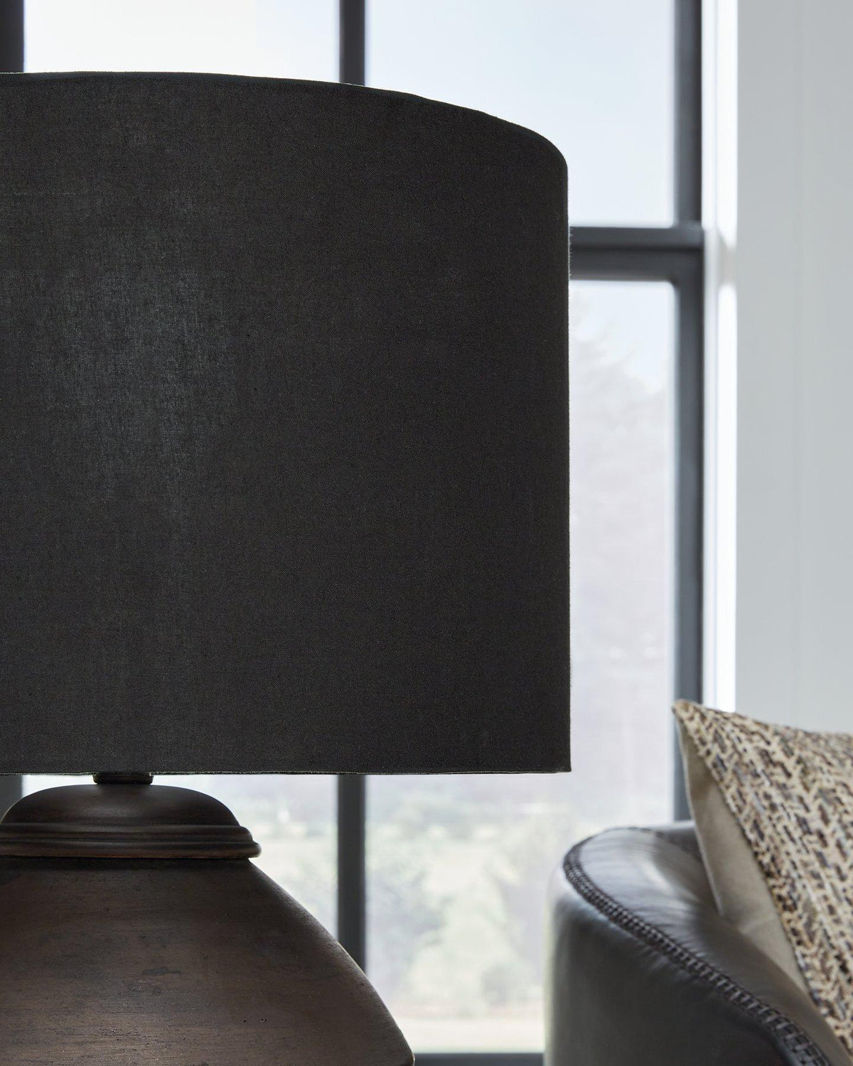 Ashley Furniture Naareman Table Lamp with a sleek base and fabric shade, ideal for enhancing home decor.