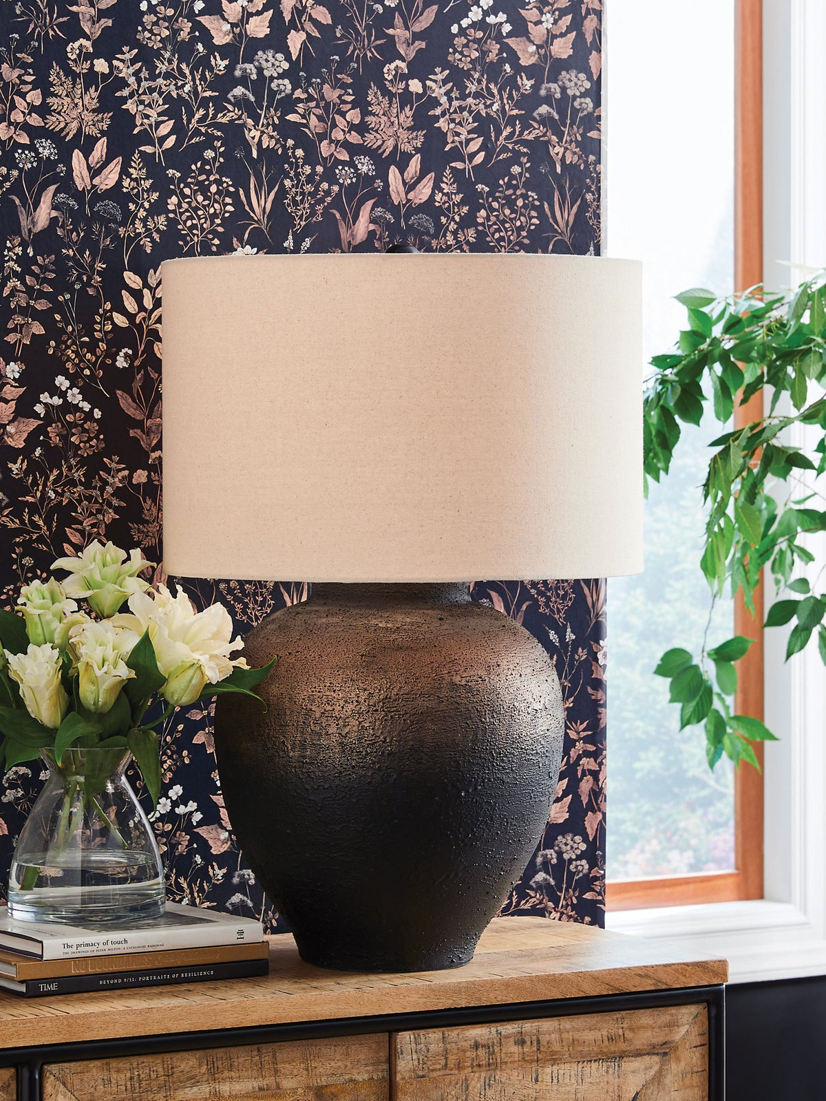 Ashley Furniture Newgerhard table lamp with a sleek base and fabric shade, ideal for bedside or living room lighting.
