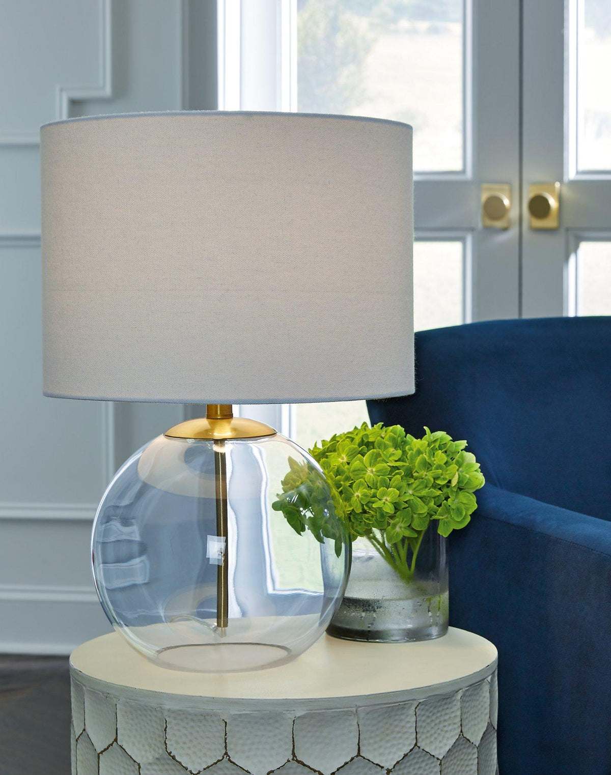 Ashley Furniture Samder table lamp with a sleek base and fabric shade, ideal for bedside or living room decor.