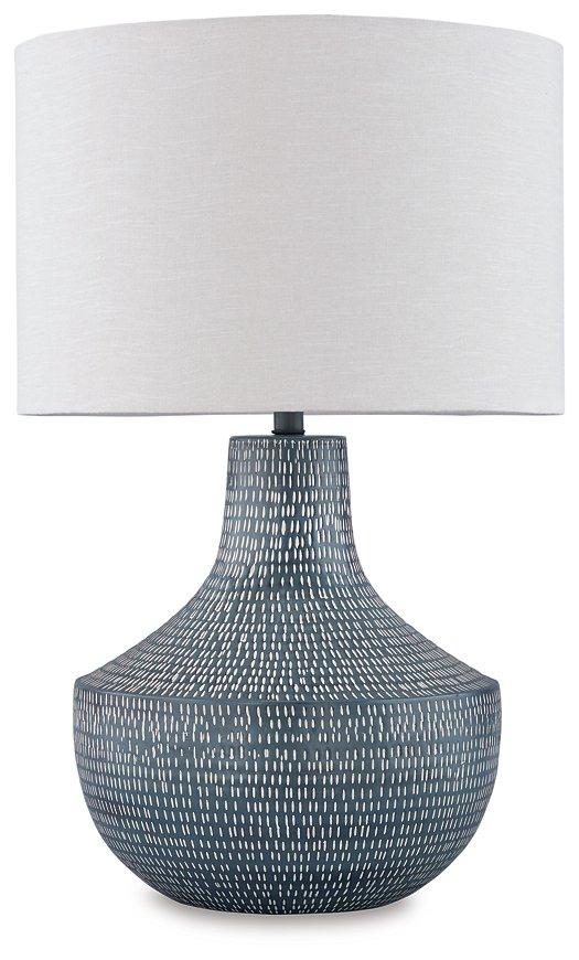 Schylarmont Table Lamp by Ashley Furniture featuring a sleek ceramic base and fabric shade on a wooden bedside table