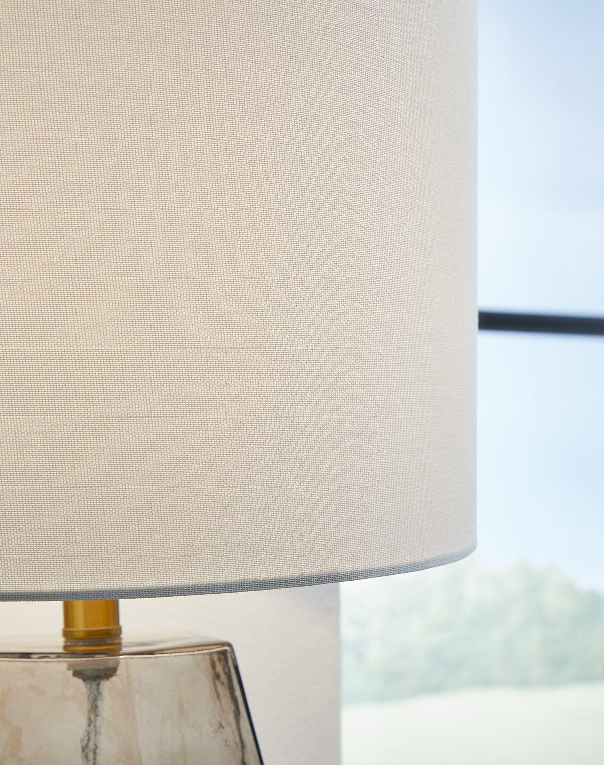 Ashley Furniture Taylor Table Lamp with a sleek base and fabric shade, ideal for enhancing living room or bedside decor.