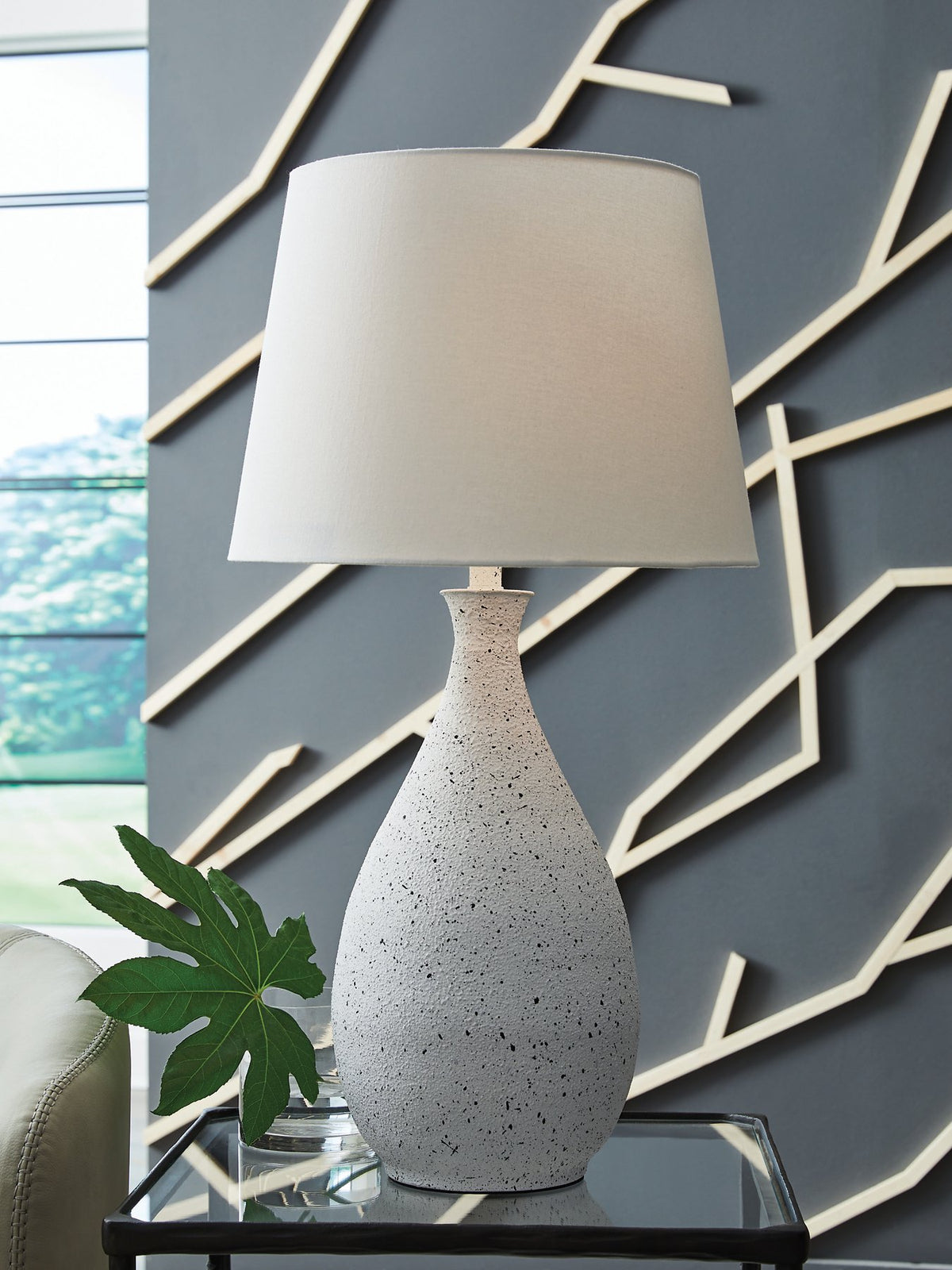 Ashley Furniture Wyattford table lamp with a classic ceramic base and fabric shade on a wooden side table.