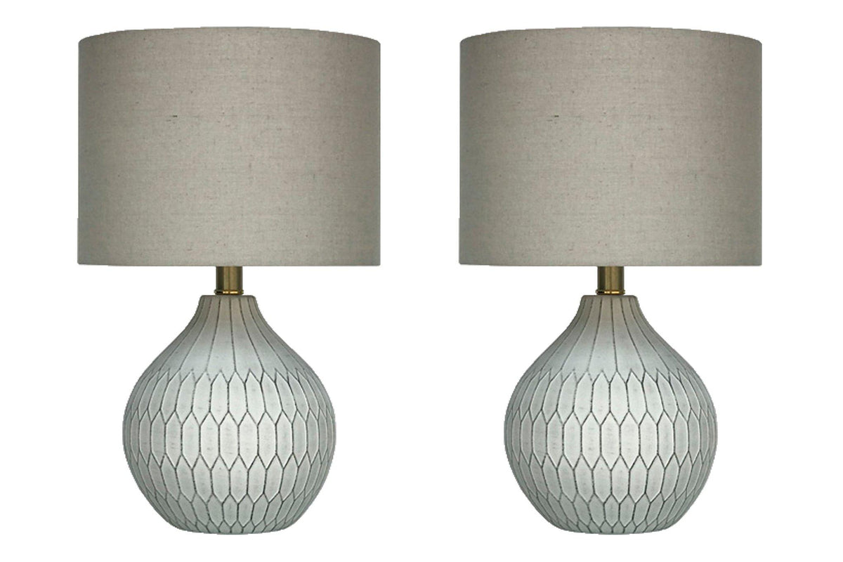 Pair of Ashley Furniture Wardmont table lamps with beige fabric shades and wooden bases, ideal for living room or bedside decor.