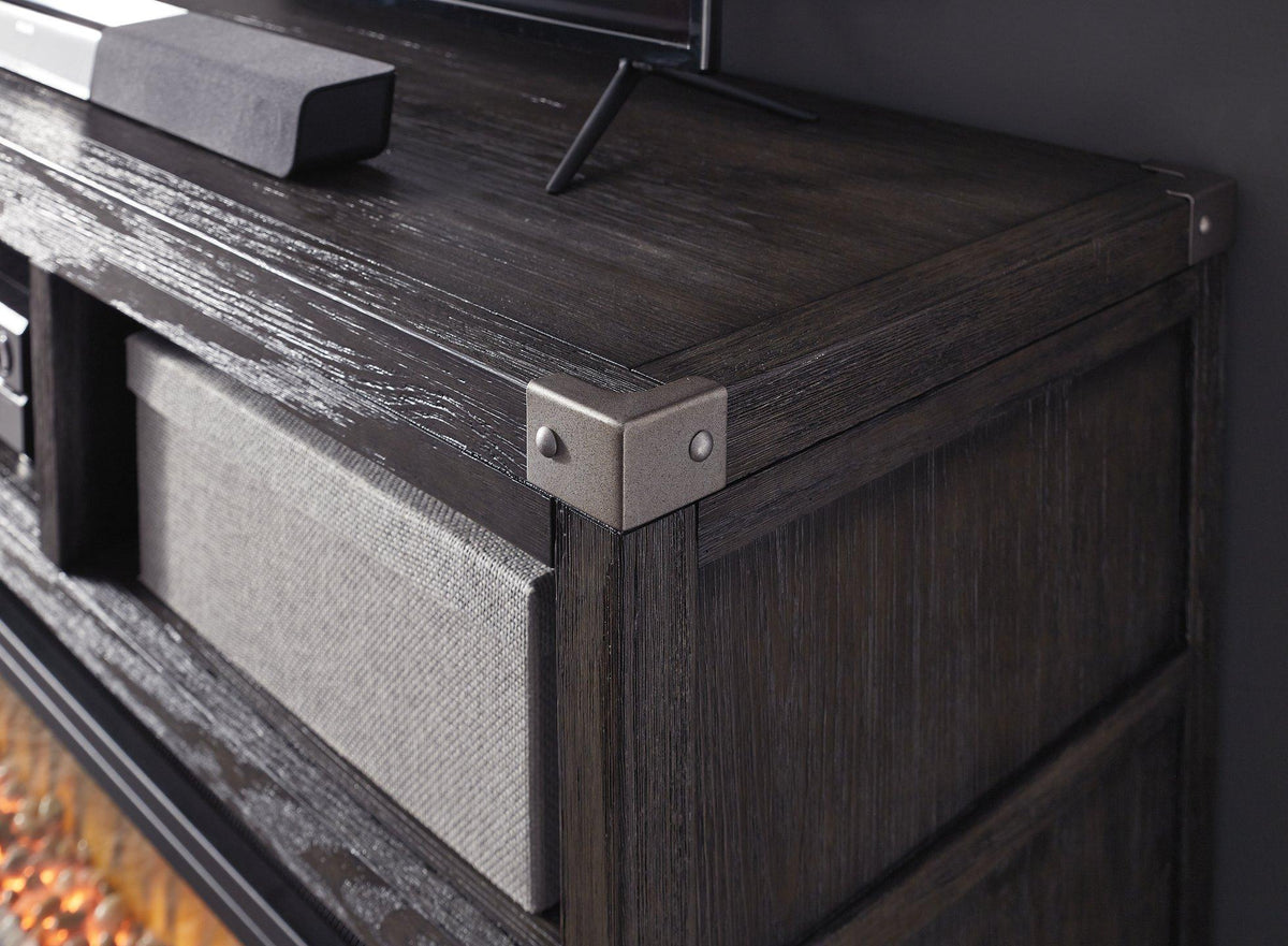 Ashley Furniture Todoe 65" TV Stand with electric fireplace, featuring wood finish, storage cabinets, and modern design.