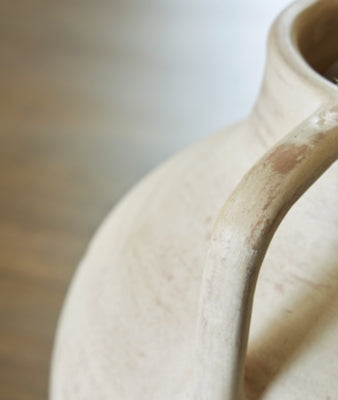Ashley Furniture Justy Vase, decorative ceramic vase with a textured finish, shown in a close-up detail shot.
