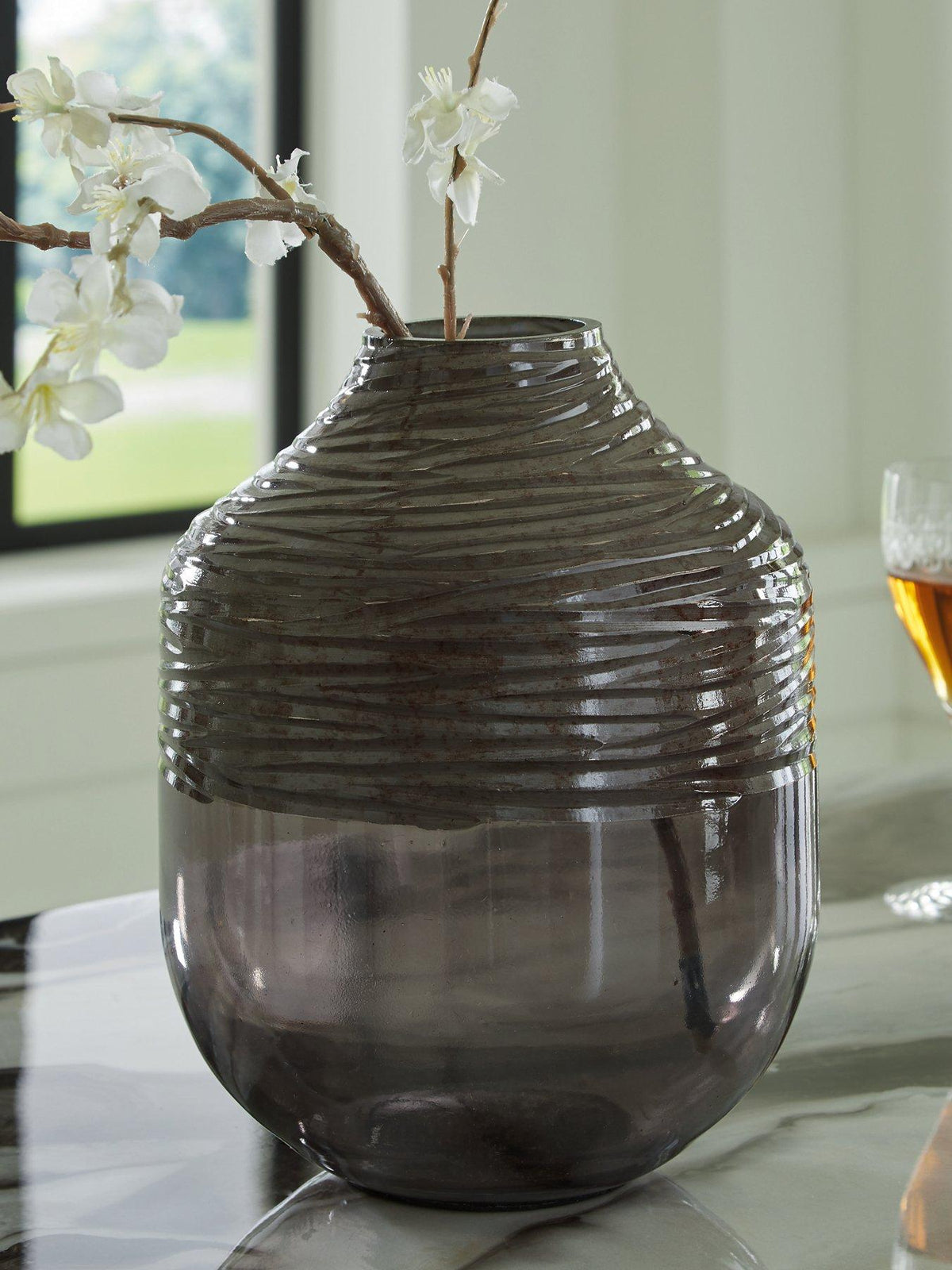 Harpwick vase by Ashley Furniture featuring a tall, elegant ceramic design with a textured surface and neutral finish.