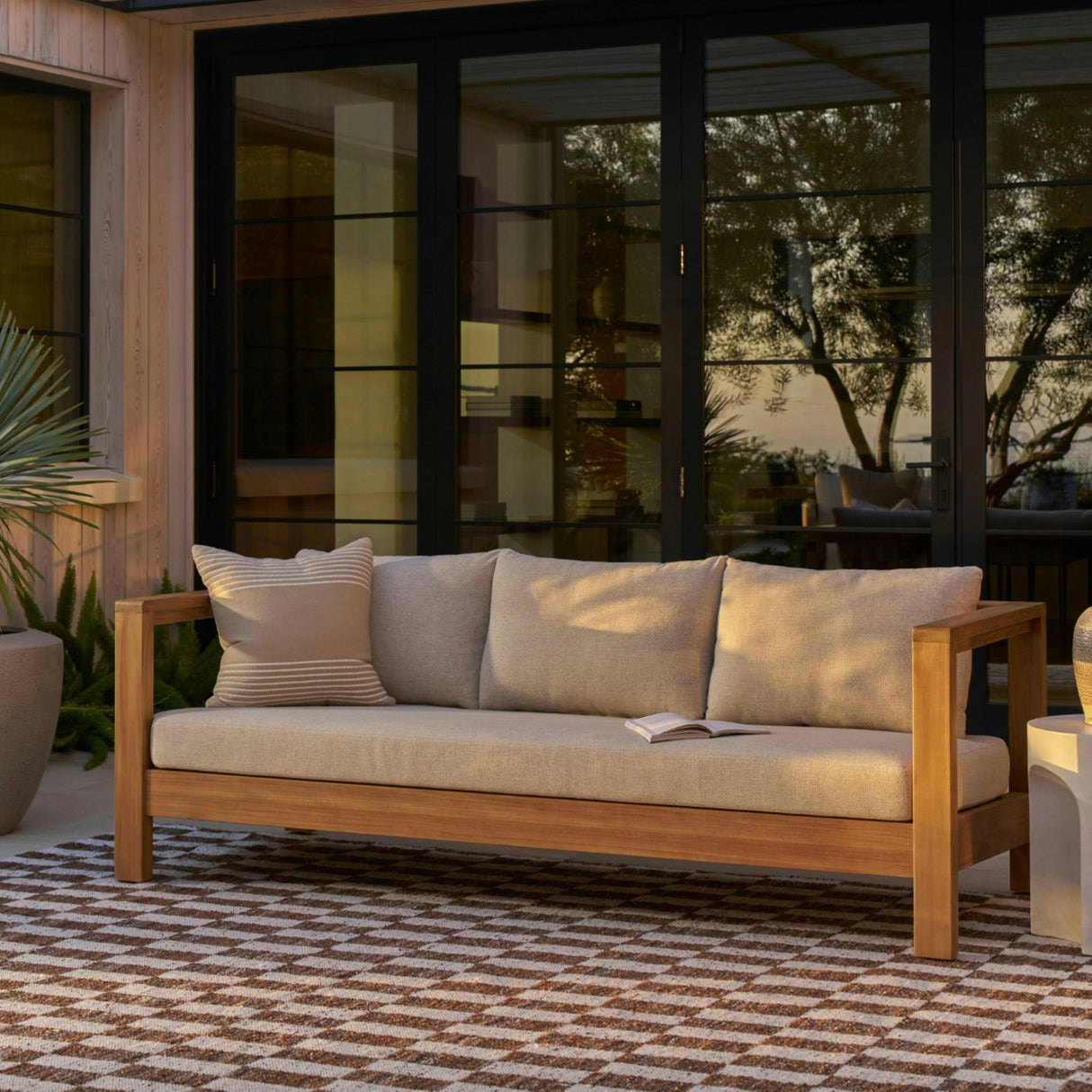 Outdoor sofa by Article, 80-inch Portside Beige outdoor sofa with plush cushions and modern design for patio or garden use.