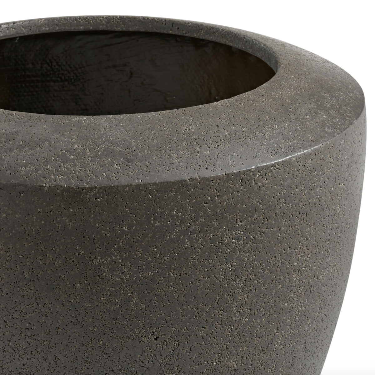 Large charcoal indoor/outdoor planter by Article, made of durable material, shown filled with lush green plants.