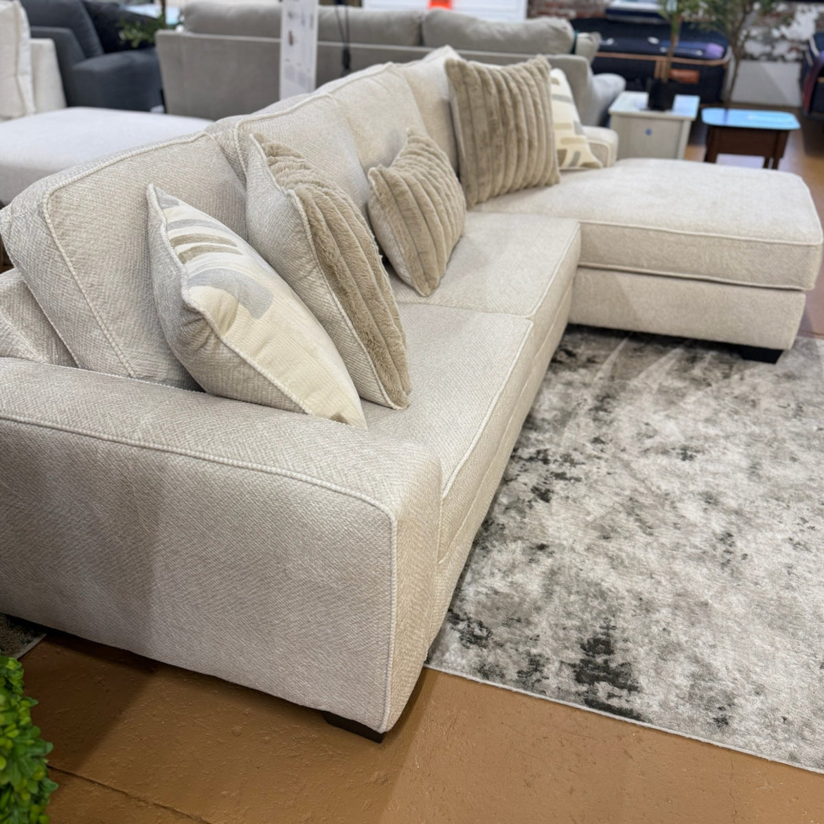 Pull Up A Couch Briarwood 2-piece sectional sofa in neutral fabric with plush cushions and modern design, shown in a living room setting.