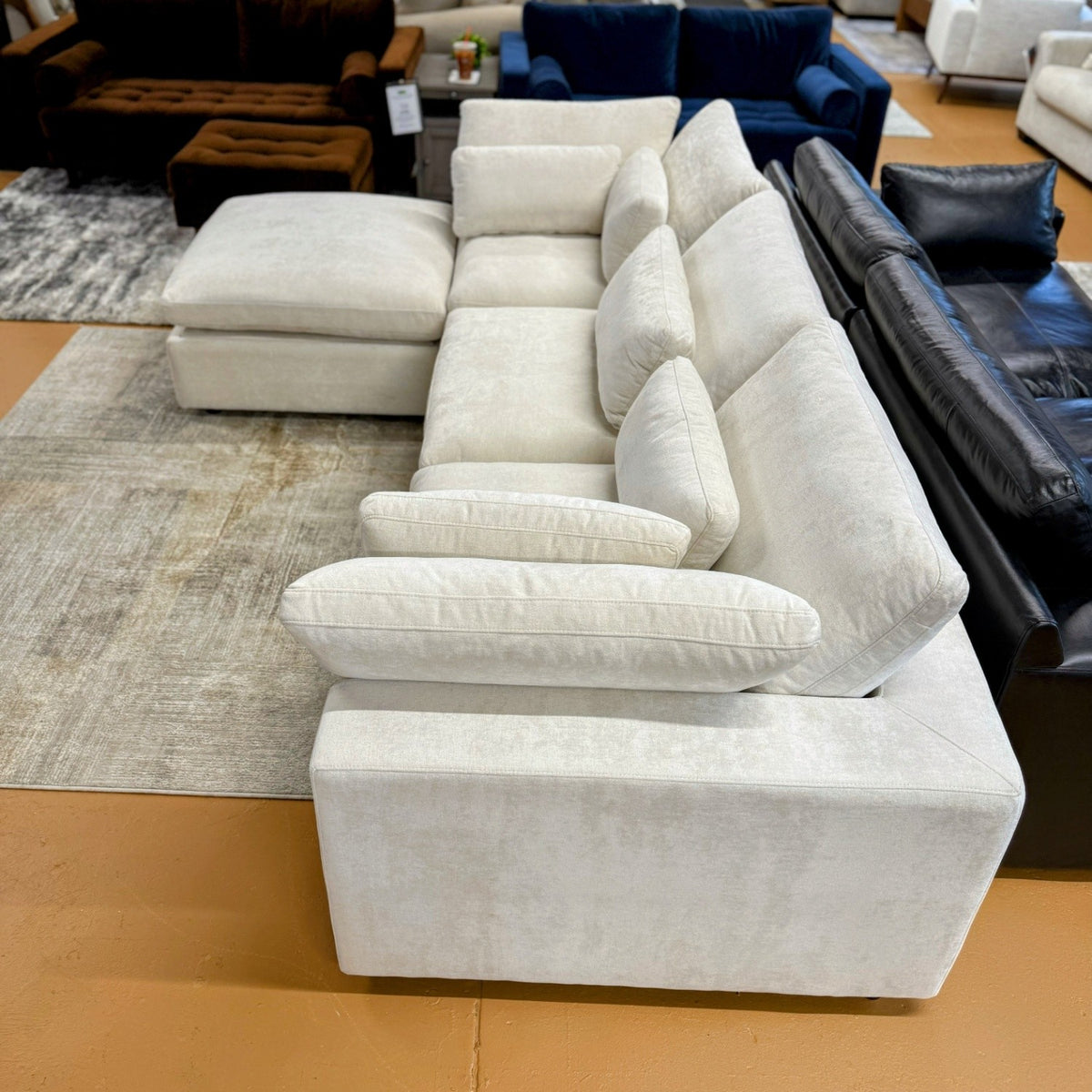 Pull Up A Couch Serenity Cloud sectional with storage ottoman, four-piece fabric sofa set in a modern living room setting