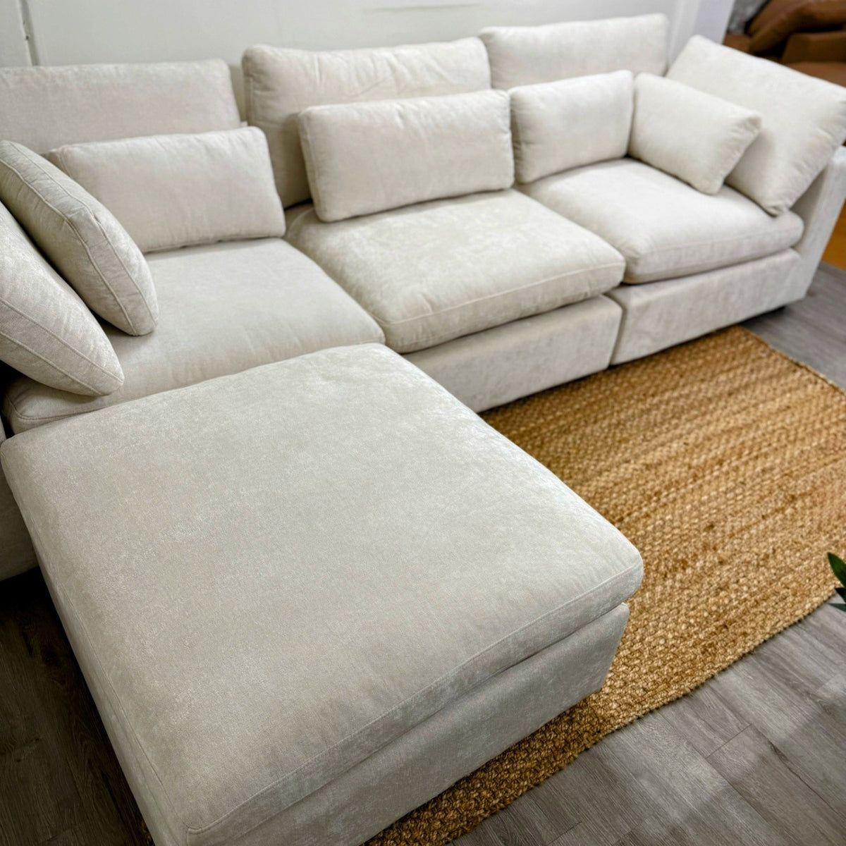 Pull Up A Couch Serenity Cloud sectional with storage ottoman, featuring plush upholstery and modern design in a cozy living space.