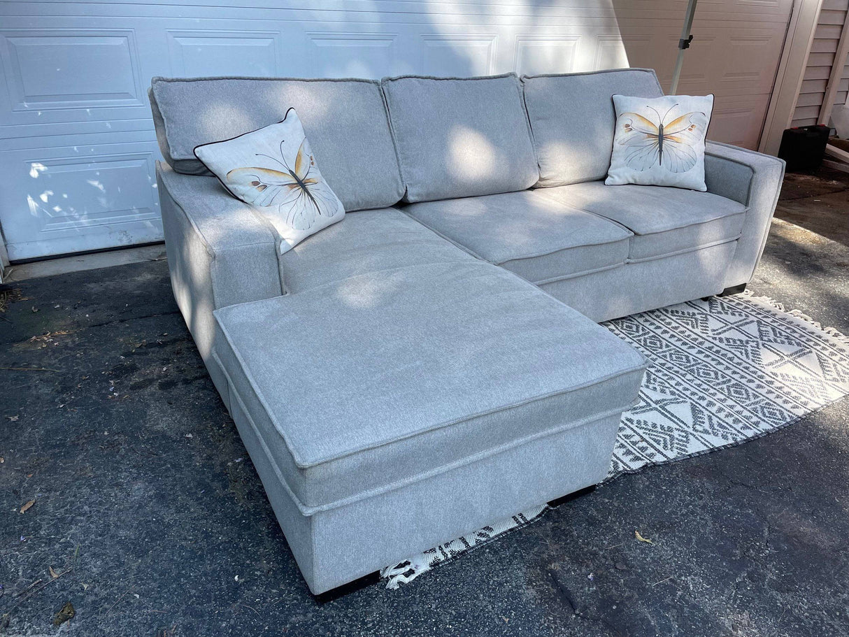 Gray 2 piece sectional with left-facing chaise, storage, and pop-up sleeper - Pull Up A Couch