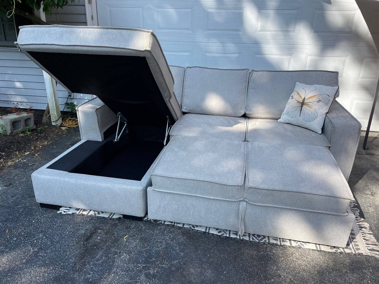 Gray 2 piece sectional with left-facing chaise, storage, and pop-up sleeper - Pull Up A Couch