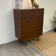 Walnut 5-drawer Cooper MCM-style dresser by Article with sleek modern design and clean lines, showcasing the dresser's front and drawer handles.