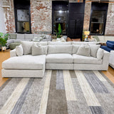 Ashley Furniture Alpine 3-piece sectional with chaise, featuring plush cushions and modern design, shown in a cozy living room setting.