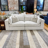 Ashley Furniture Alpine 2-piece sectional sofa with plush cushions and modern design, shown in a spacious living room setting.
