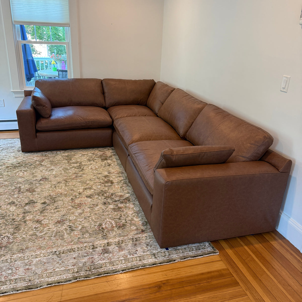 Ashley Furniture Atlas Reserve 4-piece corner sectional sofa with plush cushions and modern design, shown in a spacious living room setting.