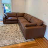 Ashley Furniture Atlas Reserve 4-piece corner sectional sofa with plush cushions and modern design, shown in a spacious living room setting.
