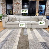 Ashley Furniture Alpine 3-piece sectional sofa with plush cushions and modern design, shown in a spacious living room setting.