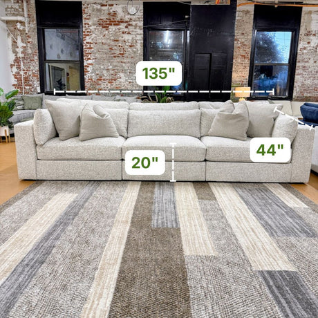 Ashley Furniture Alpine 3-piece sectional sofa with plush cushions and modern design, shown in a spacious living room setting.